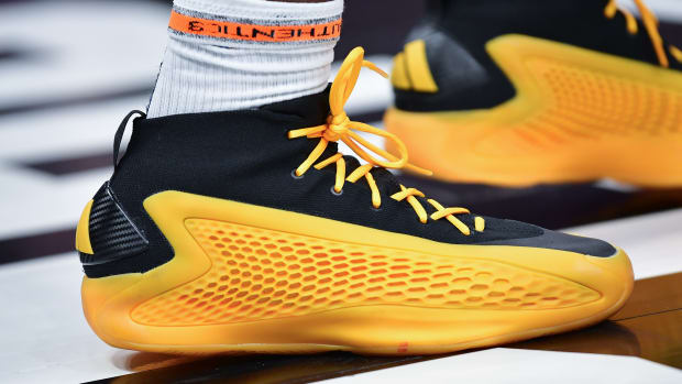 Minnesota Timberwolves guard Anthony Edwards' gold and black adidas sneakers.